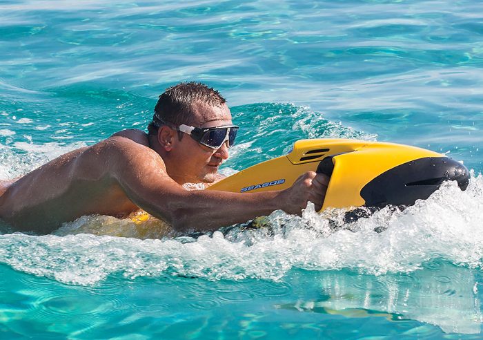 A man rides a seabob through the water